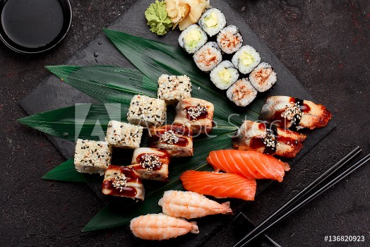Picture of Japanese cuisine Sushi set on a stone plate and dark concrete background
